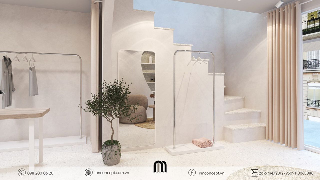 Khu vực gương soi và ghế sofa thư giãn trong shop thời trang.